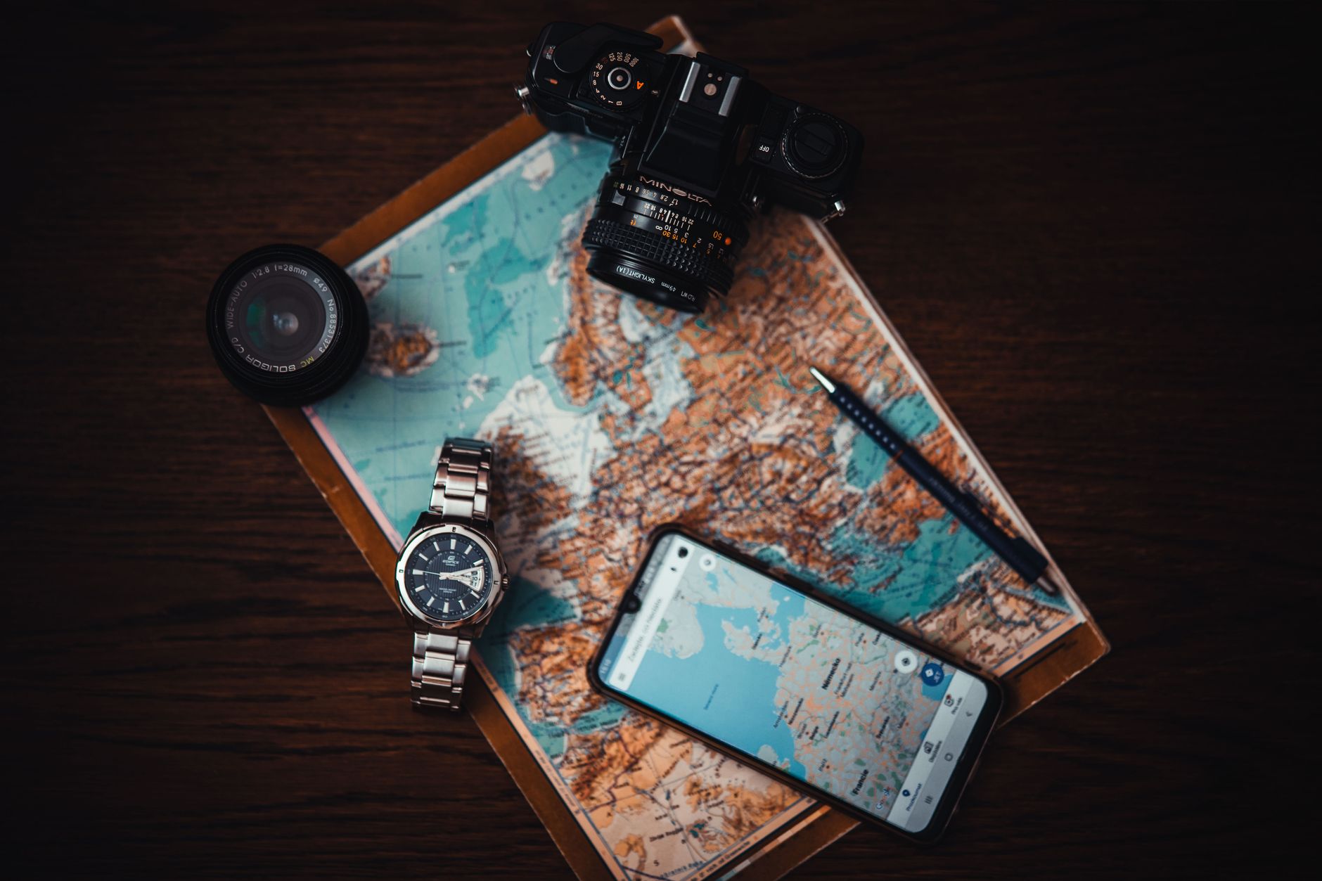 Map, phone and camera laid out for trip planning