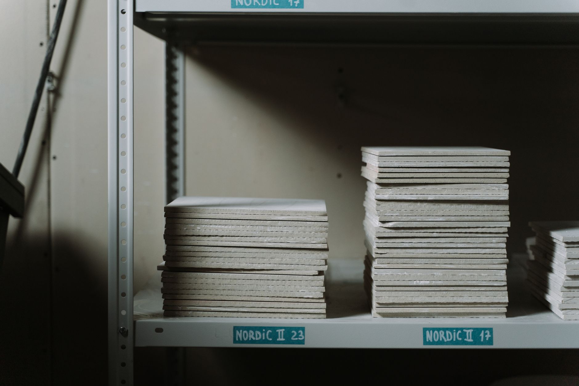 Stacked ceramic tiles on warehouse shelving