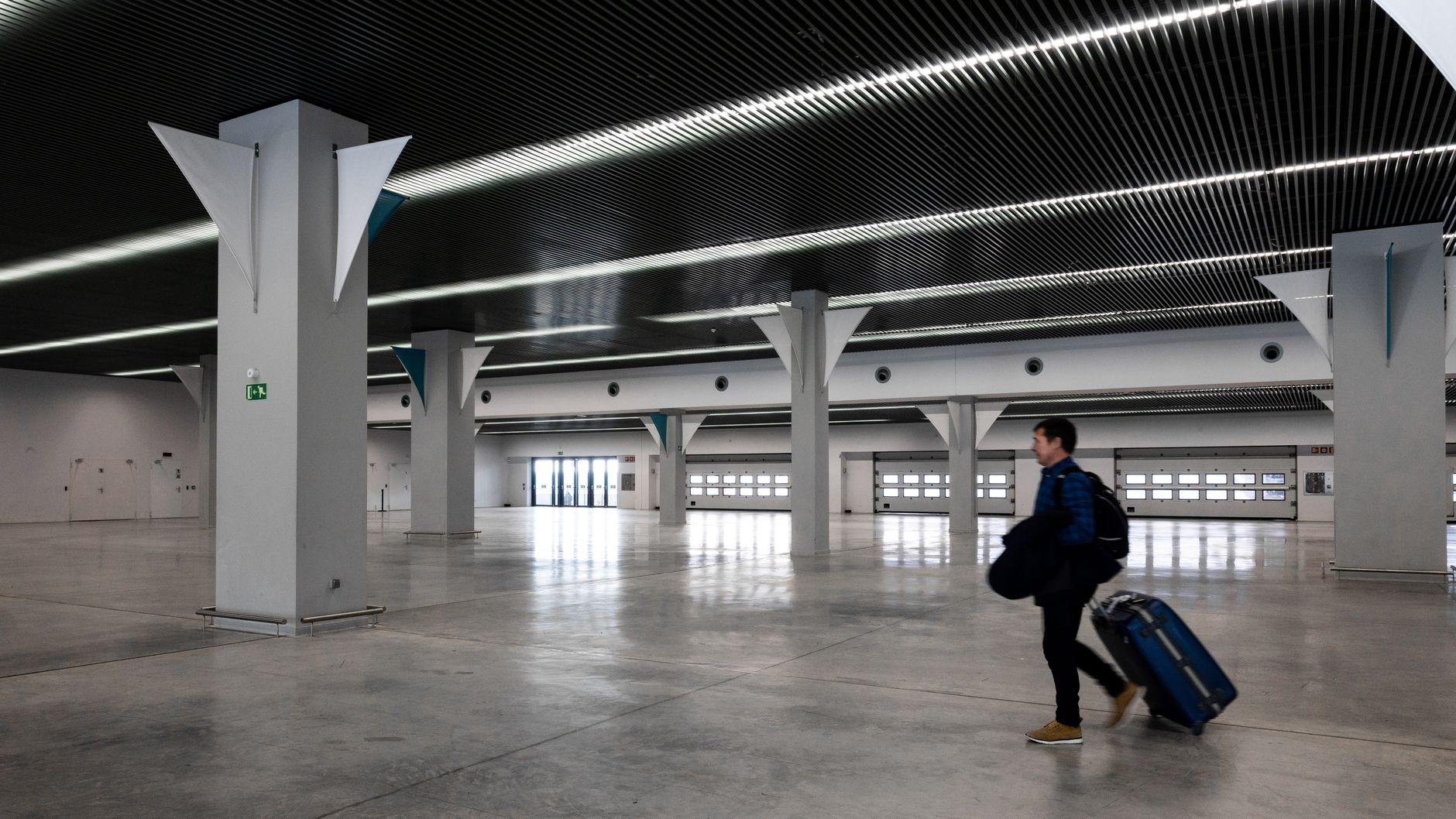 Traveller crossing a modern airport hall