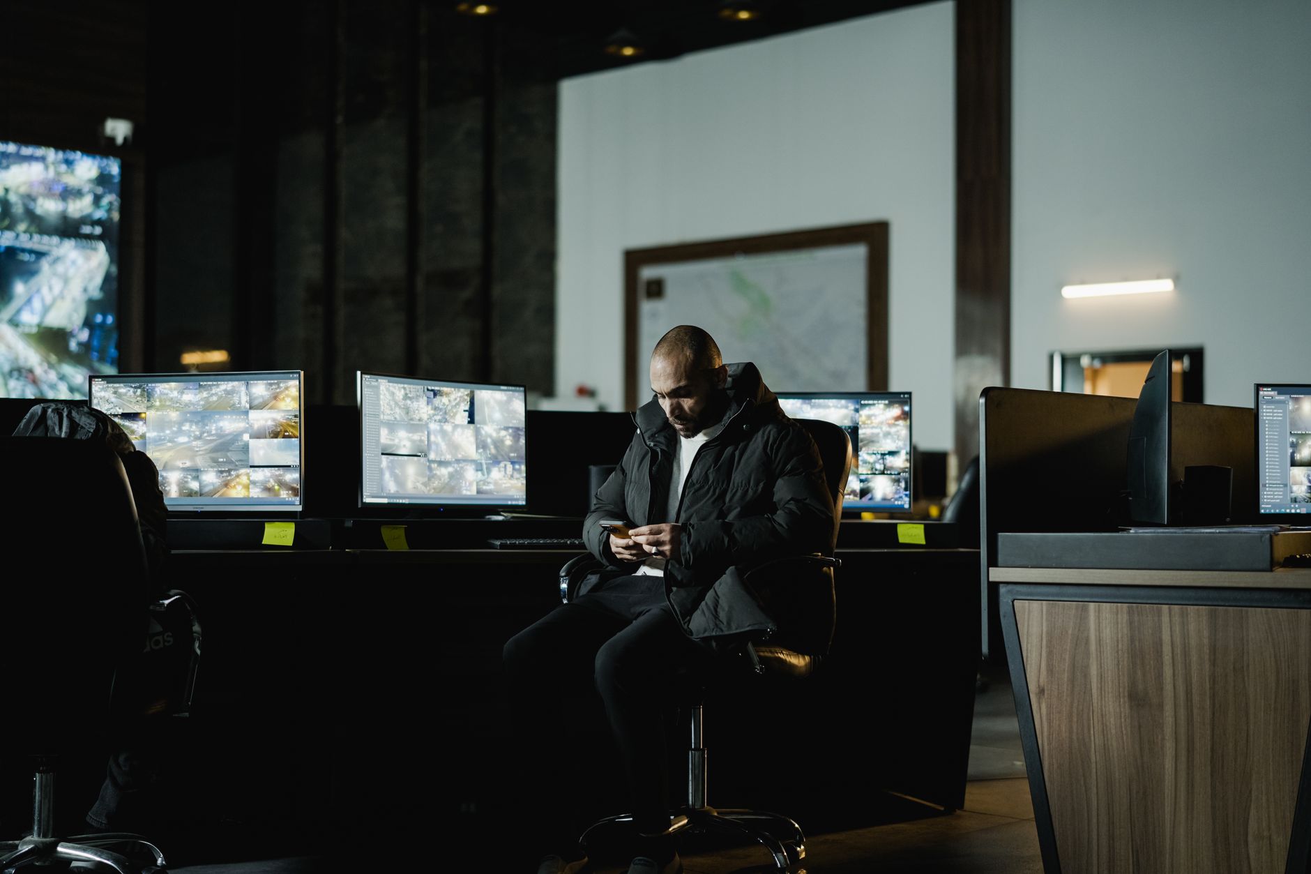 Operator monitoring a wall of security screens